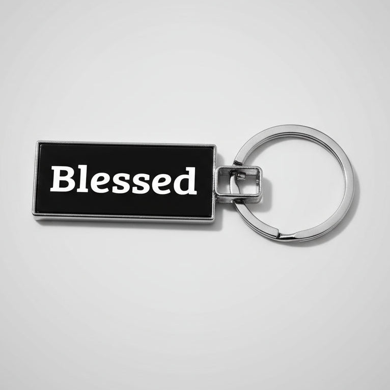 Keychain with 'Blessed' text on a textured gray background