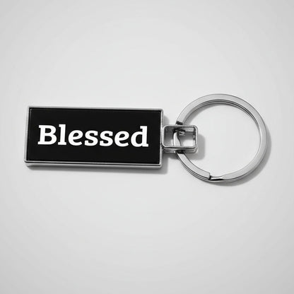 Keychain with 'Blessed' text on a textured gray background