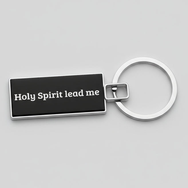 Keychain with 'Holy Spirit lead me' text on a gray background