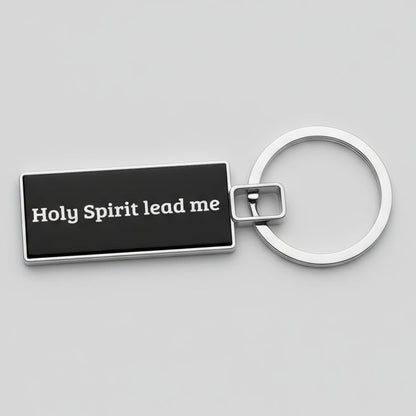 Keychain with 'Holy Spirit lead me' text on a gray background