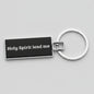 Keychain with 'Holy Spirit lead me' text on a gray background