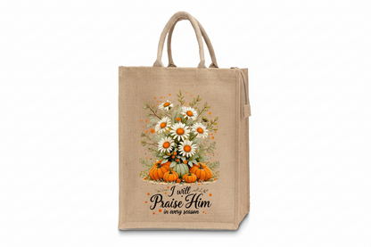 Beige tote bag with floral design and text on a wooden surface