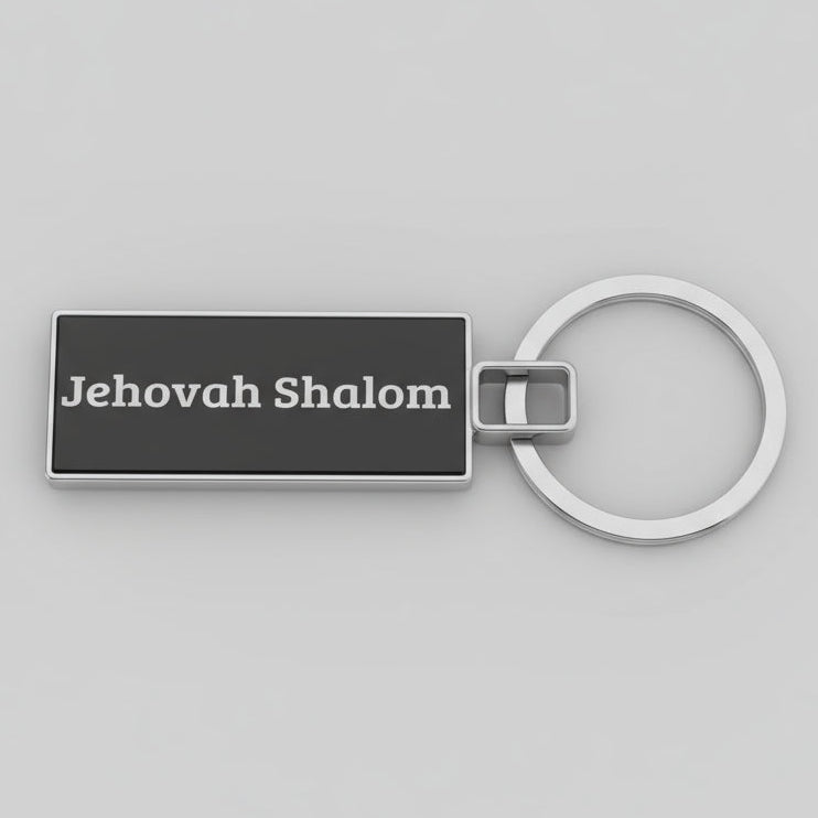 Keychain with 'Jehovah Shalom' text on a speckled gray surface