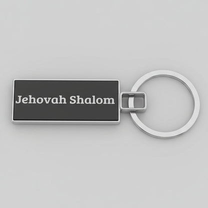 Keychain with 'Jehovah Shalom' text on a speckled gray surface