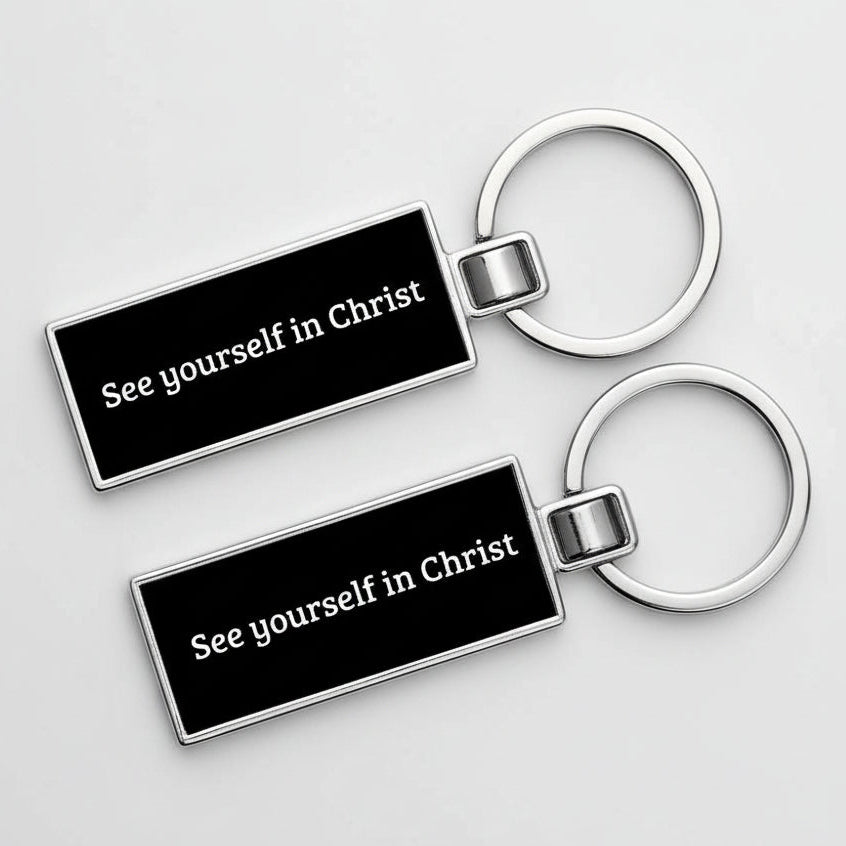 Two black keychains with 'See yourself in Christ' text on a white background