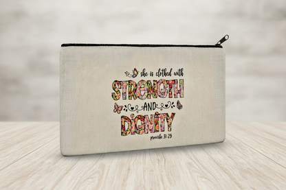 Canvas pouch with motivational quote 'She is clothed with strength and dignity' on a plain background