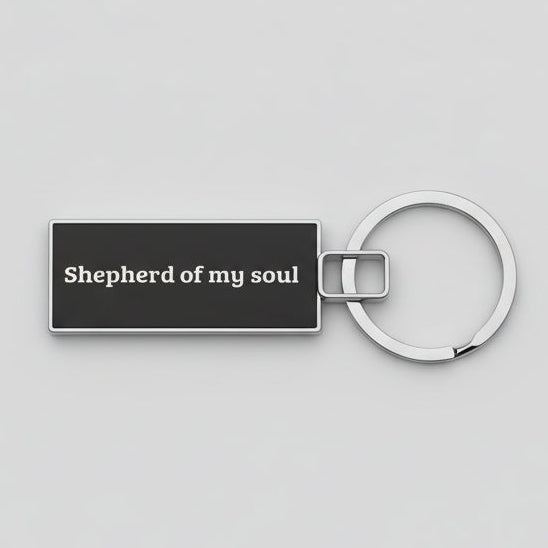 Keychain with 'Shepherd of my soul' text on a textured gray background