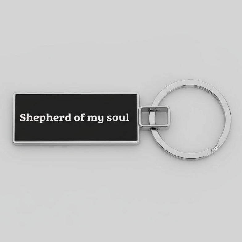 Keychain with 'Shepherd of my soul' text on a gray background