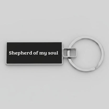 Keychain with 'Shepherd of my soul' text on a gray background